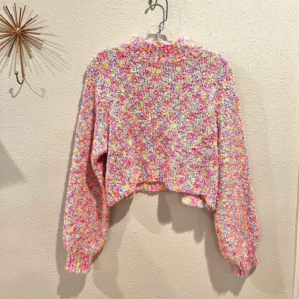 Rainbow colored sweater. Mid neck line. Somewhat cropped. Very soft.